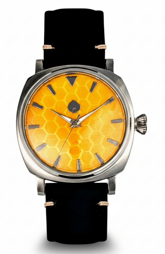 Watch with a yellow honeycomb pattern face and black strap on a white background