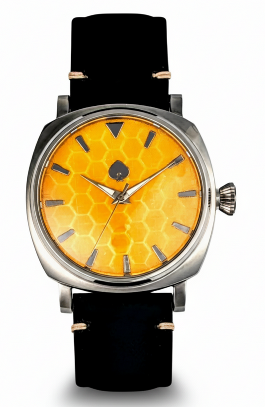 Watch with a yellow honeycomb pattern face and black strap on a white background